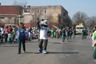 The Wildcat works the crowd as he heads east on West Fourth Street