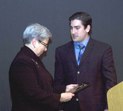 Student Government Association President Andrew S. Wisner surprises Pennsylvania College of Technology President Davie Jane Gilmour with a plaque marking her 10-year anniversary.