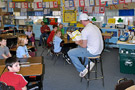 Glen R. Thomas reads to an attentive classroom