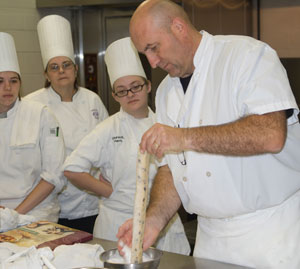 Baking consultant Dominique Homo instructs, from left, student Andrea M. Hamilton, of Shunk%3B Sue Major, assistant professor of hospitality management%2Fculinary arts%3B and student Lauren K. Harris, of Mont Alto.