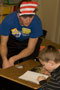 A first-grader reads to Shane Burridge (tennis)