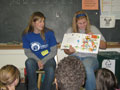 Lady Wildcats Samantha L. Mills, left, and Trisha M. Moser read to Sheridan fourth-graders