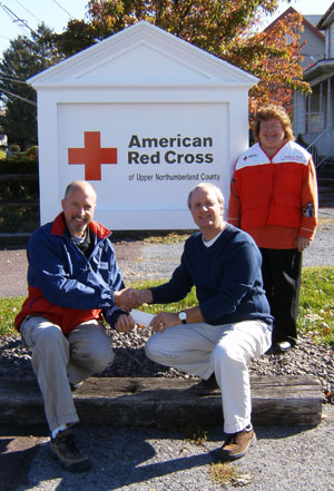 Scott Neuhard (right), of Northumberland, uncle of Fallon Pardoe-Cartegena and Jarrod Neuhard, is shown with Tom Szulanczyk, executive director, and Belinda Stifle, disaster services director, of the American Red Cross of Upper Northumberland County.