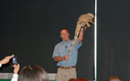Jeff Cook exhibits an iguana
