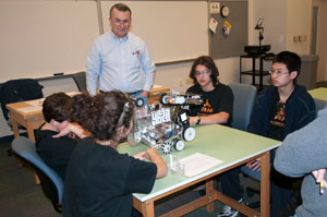 Stan Boler, associate professor of electronics at Pennsylvania College of Technology, acts as a judge during a FIRST Tech Challenge regional qualifying event at the college, listening to members of 'RM Robotics,' of Richard Montgomery High School in Rockville, Md., explain their robot%E2%80%99s design.