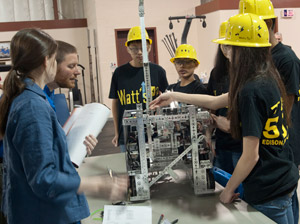 Members of the Watts Up%3F team from Say Watt Robotics in Edison, N.J., present their design to volunteer judges Rebecca Albert and Edward J. Almasy, instructor of electronics at Pennsylvania College of Technology, during the recent FIRST Technical Challenge Pennsylvania Championship Tournament at the college.