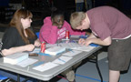 Organizer Amanda L. Twigg, of Dallastown (left) and La'tiona S. Bowie, a human services major from York, help Joshua W. Nadonley, an information technology: information assurance and security concentration major from Cresson, with his voter-registration application