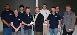 Members of Pennsylvania College of Technology's Students in Free Enterprise chapter present a $500 check to Robb Dietrich, executive director of the Penn College Foundation, for a new scholarship fund within the School of Business and Computer Technologies. At right is adviser Dennis R. Williams, associate professor of business administration/management, who made a matching gift of $500.
