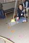 A participant practices balance and coordination via bean toss from a swing in the occupational therapy assistant lab