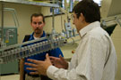 A Penn College student, right, answers questions about production of plastic bottles in the college's blow-molding lab.