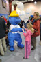 The mascot for Anadarko Petroleum Corp., a partner in the college's training of natural gas workers, interacts with festivalgoers