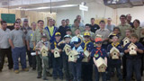 Joined by supportive adults and helpful Penn College students, Cub Scouts show off birdhouses assembled in the Carl Building Technologies Center