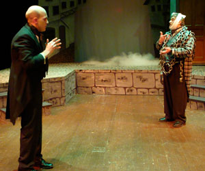 Ebenezer Scrooge (Stephen Furey) is visited by the prescient spirit of Jacob Marley (IT alumnus Keith A. Wagner), wearing the ponderous chains he forged in life.