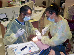 Pennsylvania College of Technology dental hygiene students Mahfuzur 'Sunny' Rahman, of Williamsport, and Rachel A. Davis, of Littlestown, provide dental care to a child during a Pennsylvania Dental Hygienists%E2%80%99 Association Sealant Saturday event at the college.