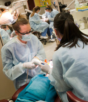 Pennsylvania College of Technology dental hygiene students Carly S. Determan, of East Stroudsburg, and Olivia G. Jekielek, of Punxsutawney, examine a child in the college%E2%80%99s Dental Hygiene Clinic.