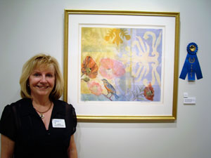 Sharon Cressinger-McCuen, of Selinsgrove, a retired educator from the Williamsport Area School District, was awarded first place for her work %E2%80%9CRed Poppies with Blue Bird%E2%80%9D during an exhibit for K-12 art teachers at The Gallery at Penn College.