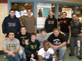 Sigma Pi brothers gather in front of a poster for the Tracy A. Garis memorial fund