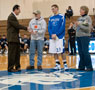Joe Simon, with parents George and Michele Simon, meet the coach at halfcourt