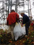 Faculty member Debra J. Buckman, right, takes part in rainy-day cleanup