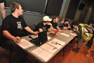 Club officers, including President Dustin Bailey (seated at extreme right), preside over a meeting in Penn's Inn