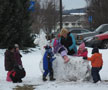 Learning Center children (with assistant group leader Regina G. Andes) take turns 'riding' snow sculpture