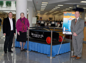 Gathered around the Soap Box Derby car driven by 1951 national champion Darwin Cooper are, from left, Donald Noviello, assistant director of the Williamsport Soap Box Derby%3B Pennsylvania College of Technology President Davie Jane Gilmour%3B and James F. Campbell, race director.