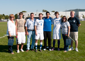 William DeAngelo (8) and Patrick Kehoe (13) join their families and coach Enrique Castillo for Senior Day honors