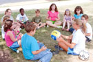 Campers form a soccer circle with Michelle R. McNett, a Penn College alumna and former Wildcat athlete, a Camp ESCAPE student assistant