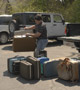 Richard M. Norgard, incoming 2012-13 president of Penn College's Lambda Nu Chapter of Delta Mu Delta, unloads suitcases in the parking lot of Families United Network Inc.