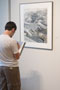 A student assesses one of the pieces on display