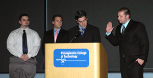 Andrew S. Wisner, at podium, administers the oath of office to his successor, Brian D. Walton.