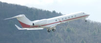 With the Appalachian foothills as a backdrop, huge aircraft gains altitude on takeoff from Montoursville