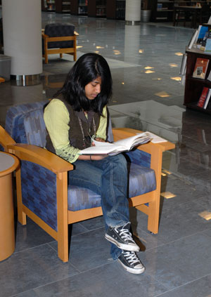 Loyalsock Township High School student Tazrin Hossain strikes a familiar pose%3A ensconced in a library, book in hand.