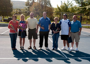 Coach Robert Kemrer, center, joins Rachel Emmons, Adam Groff and their parents during Saturday's Senior Day ceremony