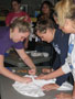From left, volleyball players Alyssa N. Millard, Tara M. Powell and Ashley R. Matson collaborate on a wearable work of art
