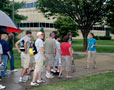 Undeterred by sprinkles, admissions representative Ashley N. Follmer leads the day's first tour