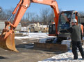 Lester L. 'Budd' Greevy, instructor of diesel equipment technology at Penn College, directs a student operator