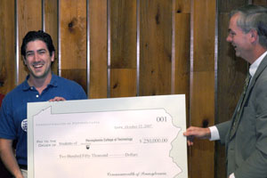 Andrew S. Wisner, 2007-08 Student Government Association president, accepts a symbolic tuition-reimbursement check from state Rep. Matthew E. Baker, a member of Pennsylvania College of Technology's Board of Directors.
