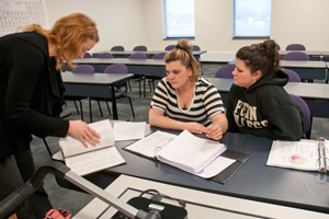 Course study leader Tara C. Jordan, left, offers tutoring in Human Anatomy and Physiology I to pre-physician assistant student Nychol M. Shook, center, and pre-nursing student Alexandria V. Martin in the science wing of the Hager Lifelong Education Center, where the course is taught.
