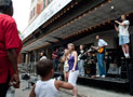 A videographer captures the crowd during a performance by the Uptown Music Collective