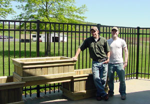 Pennsylvania College of Technology construction students Bradley D. Martin, left, and Jacob D. Carlson stand by the outdoor planters that they built, a dream come true for the Valley View Nursing Center near Montoursville.