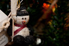 Handcrafted snowman wears  and brings  a smile