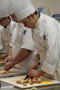 Culinary arts and systems student Richard J. McGlynn and classmates chop mushrooms for the second course