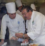 Christopher Harris listens intently to Chef Robert Kinkead%E2%80%99s instructions.