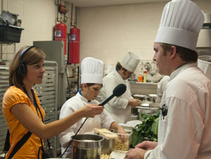 Emily Wiley, a WPSU producer, interviews Pennsylvania College of Technology culinary arts and systems student Noah D. Deibler-Gorman, of Lewisburg, in the kitchens of Penn College%E2%80%99s School of Hospitality.