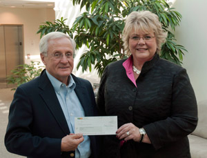 Ron Wilson, district manager for Waste Management Inc., presents a check to Debra M. Miller, director of corporate relations at Pennsylvania College of Technology.