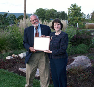 Mary A. Sullivan, dean of Pennsylvania College of Technology's School of Natural Resources Management, honors William D. Wells for his 21 years of service to the Horticulture Advisory Committee. (Photo by Carl J. Bower, horticulture instructor)