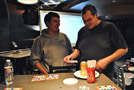 Eric J. Morris (right) checks Ryan M. Enders' winning bingo card, good for a $40 prize
