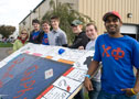Chi Phi fraternity brothers, with their 'Stand Still' float and Erin Datteri, assistant director of student activities for Greek life and leadership