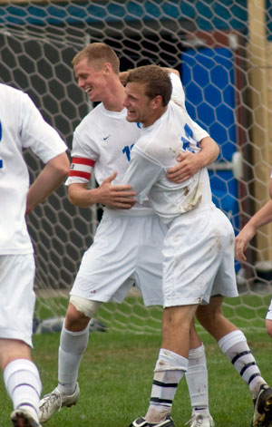 Steven Bullock is congratulated after scoring the winning goal in Saturday's overtime victory against Penn State Hazleton. (Photo by Jessica L. Tobias, student photographer)